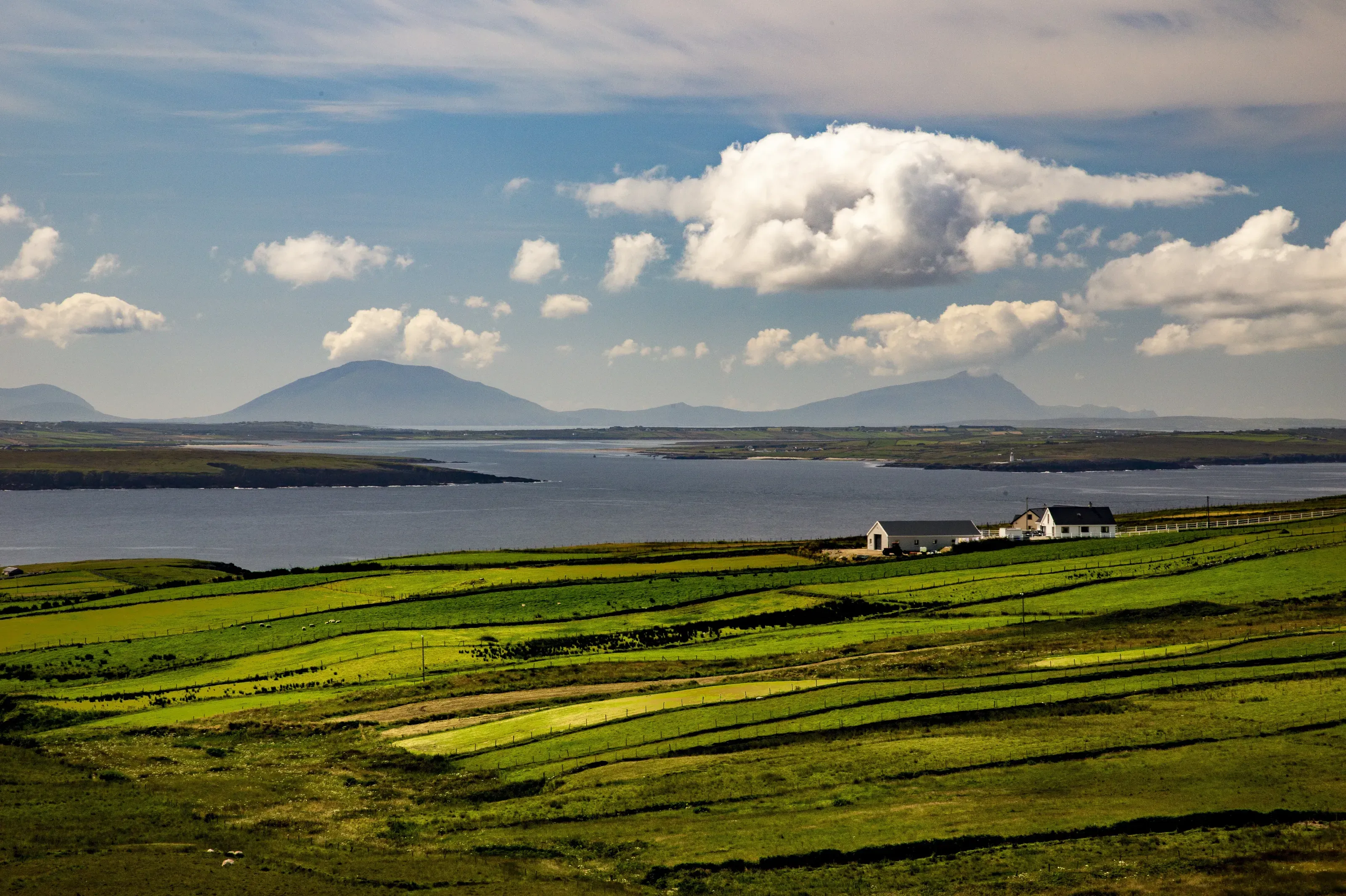 Green fields and Valentia Island under a bright Kerry sky