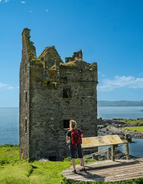 Sylvia looking out to sea from beside a ruined Kerry tower house