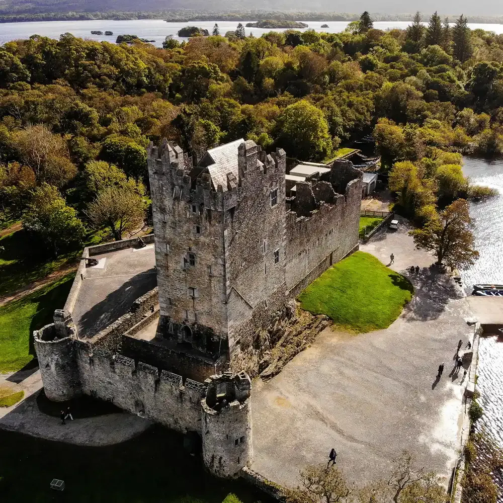 Aerial view of a Kerry castle ruin beside a lake